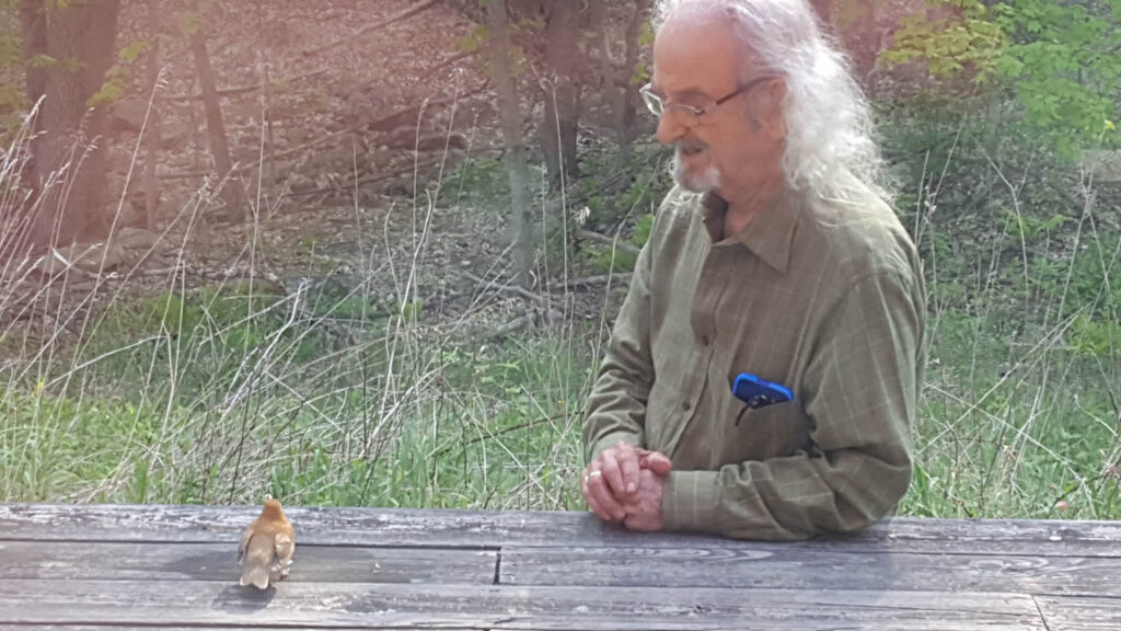 Photo of author/illustrator Latif Jiji with a small bird.
